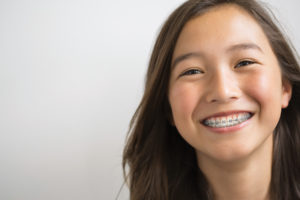 Portrait of smiling brunette girl with braces